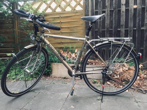 Fahrrad von der Seite vor einem kartenzaun